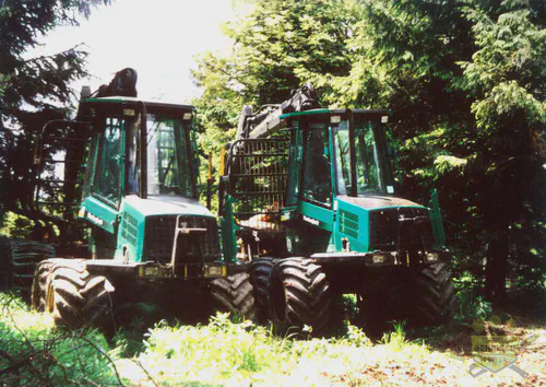 Zwei Timberjack-Forstmaschinen nebeneinander auf einer Lichtung im Fichtenwald